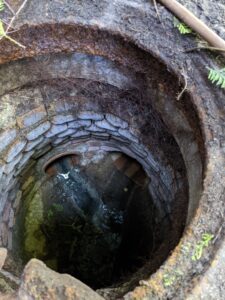 Peeking inside a wastewater collection system to collect a sample for SARS-CoV-2 RNA testing.